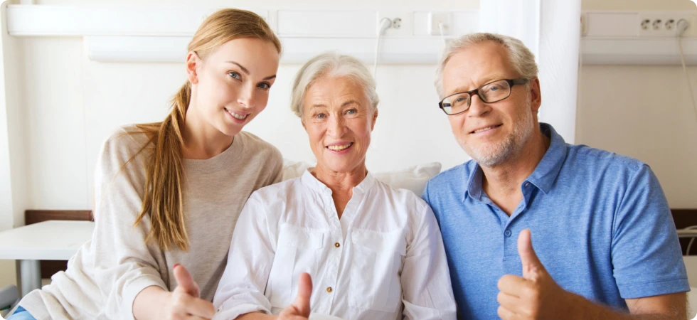 a happy family showing their thumbs up